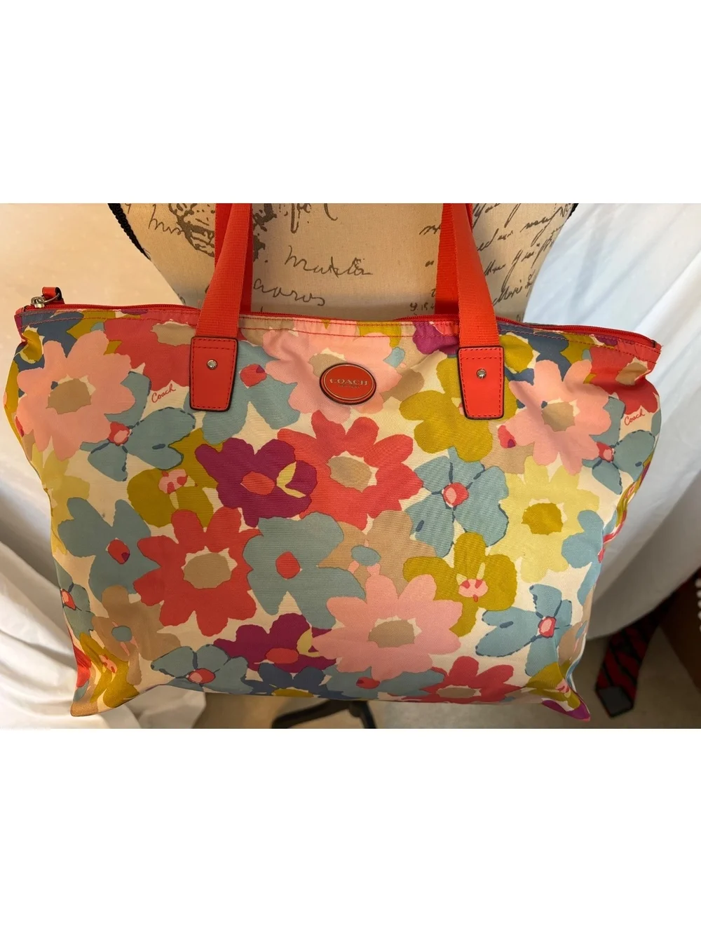 Bright and cheerful Coach tote featuring an oversized multicolor floral print.